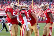 San Francisco 49ers quarterback Trey Lance, left, celebrates after throwing a touchdown pass to ...