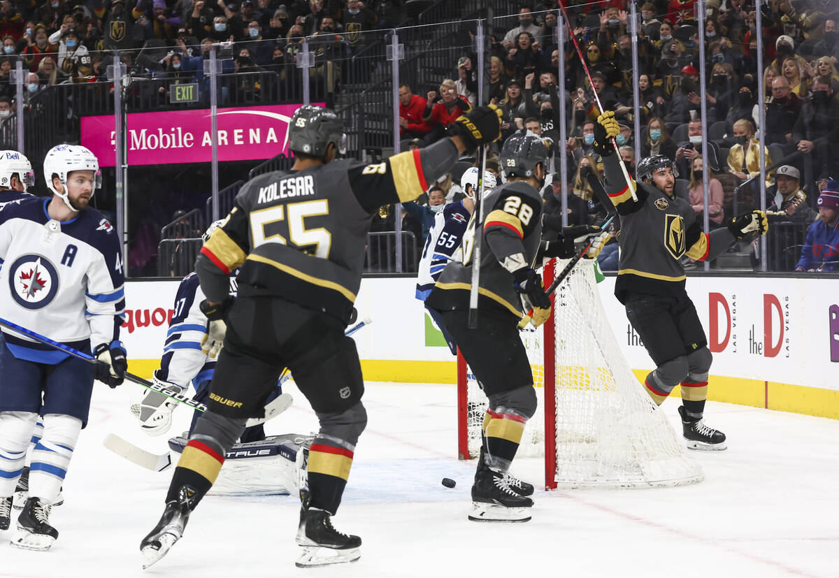 Golden Knights center Michael Amadio, right, celebrates his goal against the Winnipeg Jets duri ...