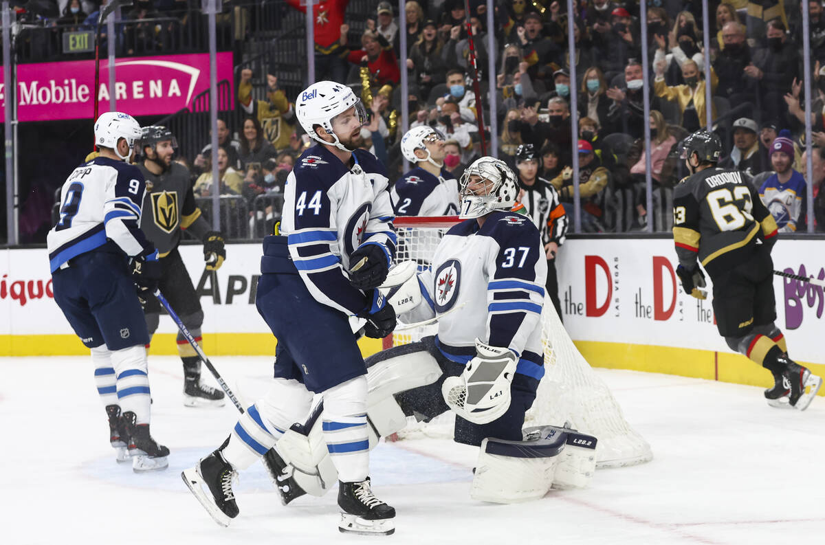 Winnipeg Jets goaltender Connor Hellebuyck (37) gives up a goal to Golden Knights right wing Ev ...