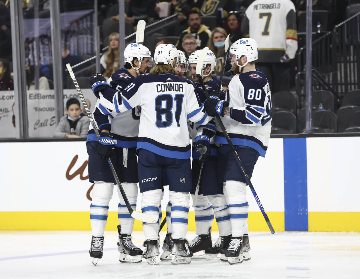The Winnipeg Jets celebrate after scoring against the Golden Knights during the second period o ...