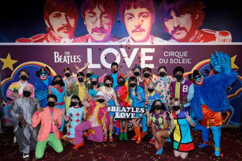 Cast members pose during a pop-up performance before the grand reopening of "The Beatles LOVE B ...