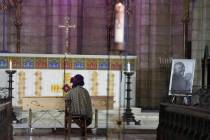 Mpho Tutu, sits with the coffin of her father Anglican Archbishop Emeritus Desmond Tutu during ...