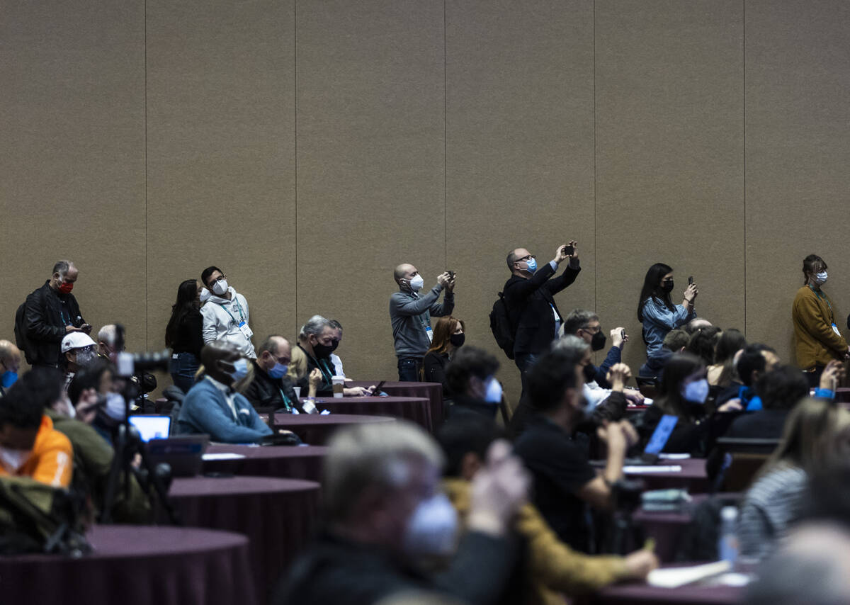 Attendees use their phones to record during the "Tech Trends to Watch" session at CES ...