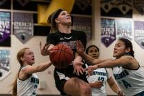 Faith Lutheran HighÕs Raina Forgue (23) surrounded by Silverado HighÕs players as she ...