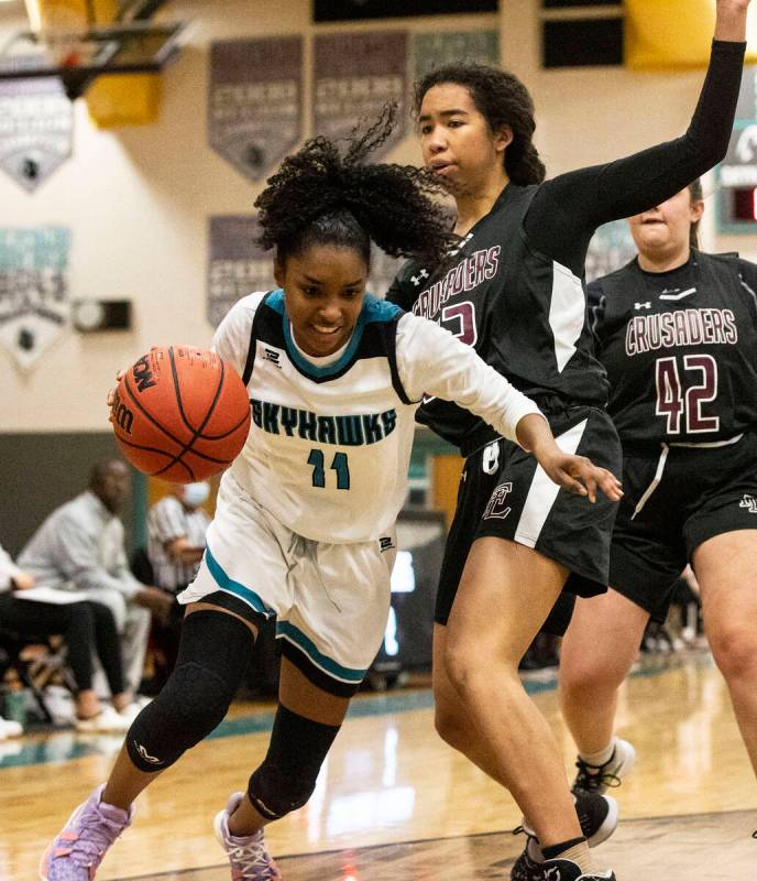 Silverado HighÕs Ashley Saxton (11) drives past Faith Lutheran HighÕs Ariel Thomas (2 ...