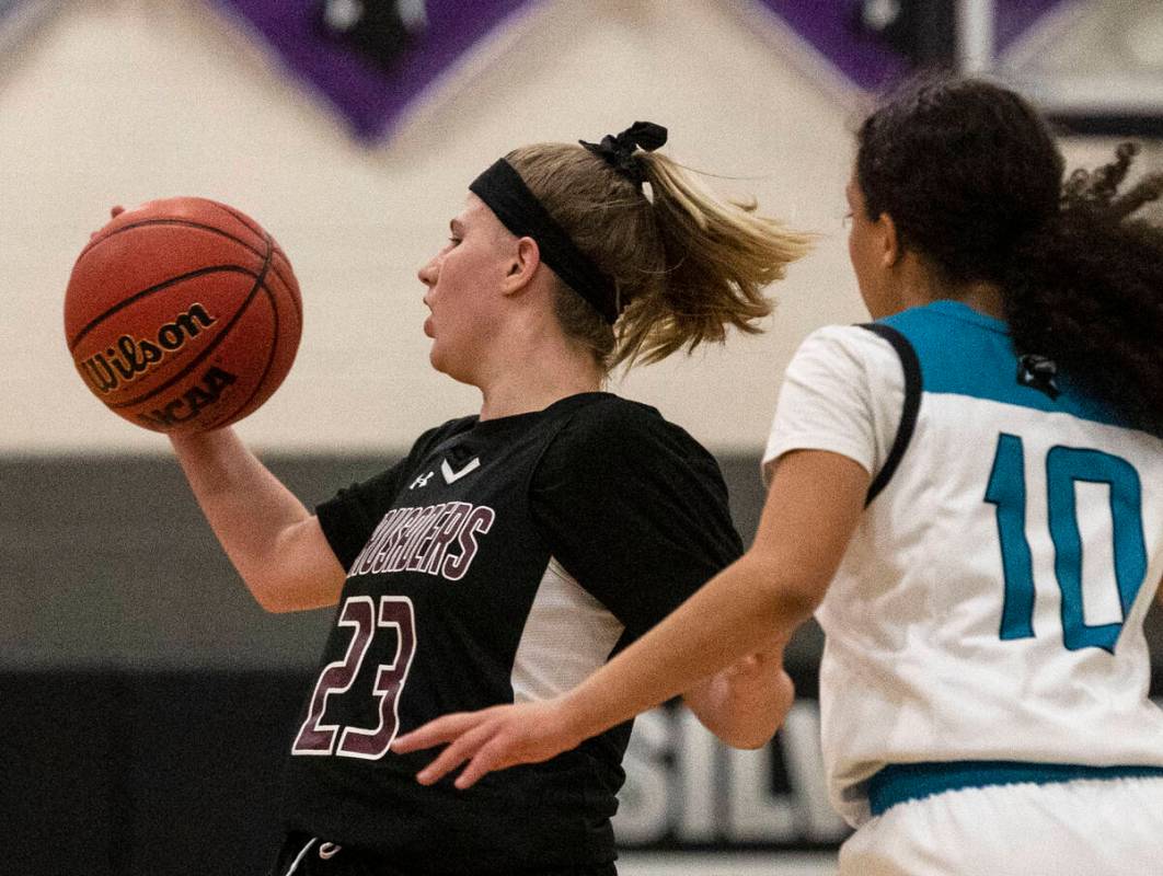 Faith Lutheran HighÕs Raina Forgue (23) catches a pass as Silverado HighÕs Timia Thom ...