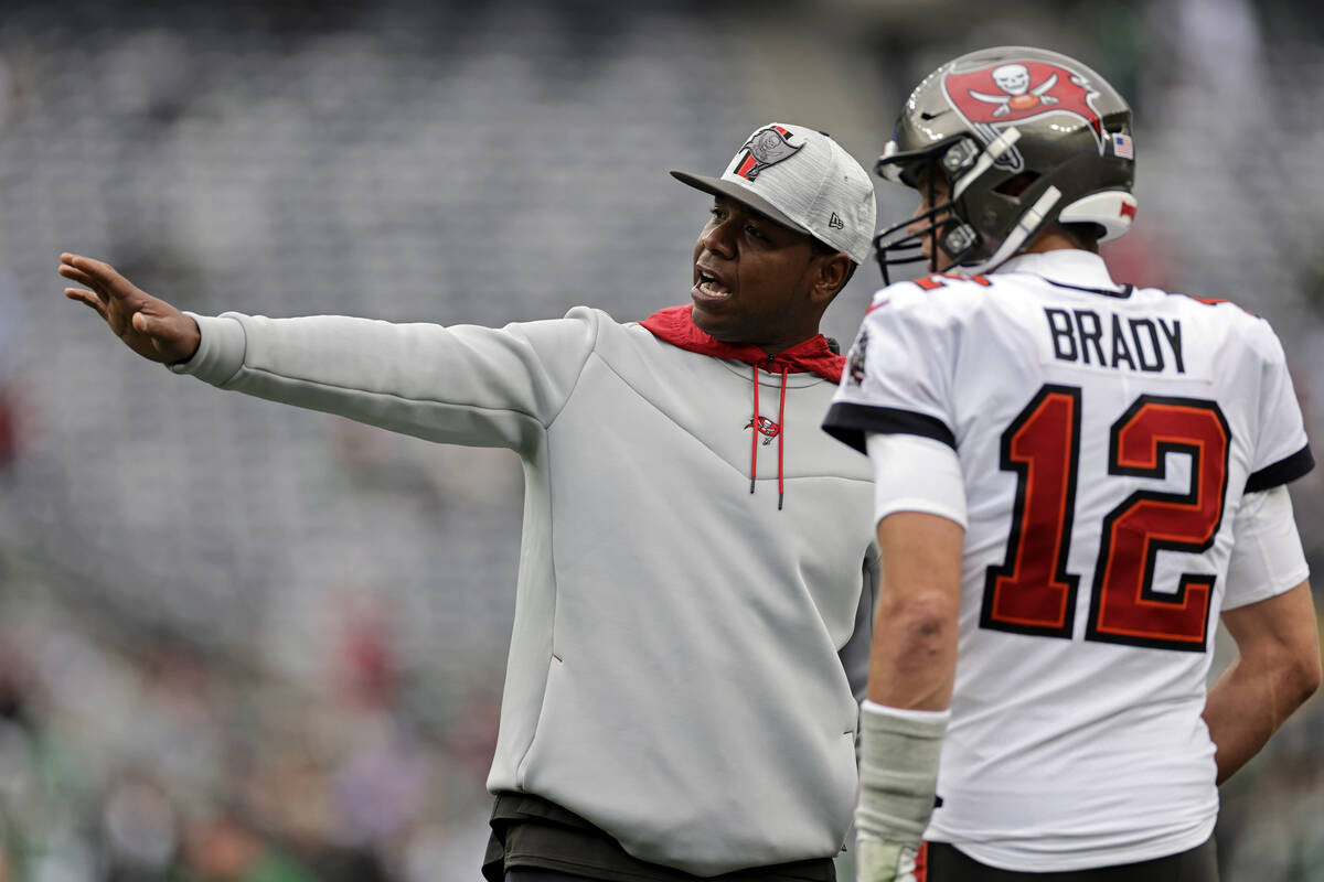 Tampa Bay Buccaneers offensive coordinator Byron Leftwich talks to Tom Brady on the field befor ...