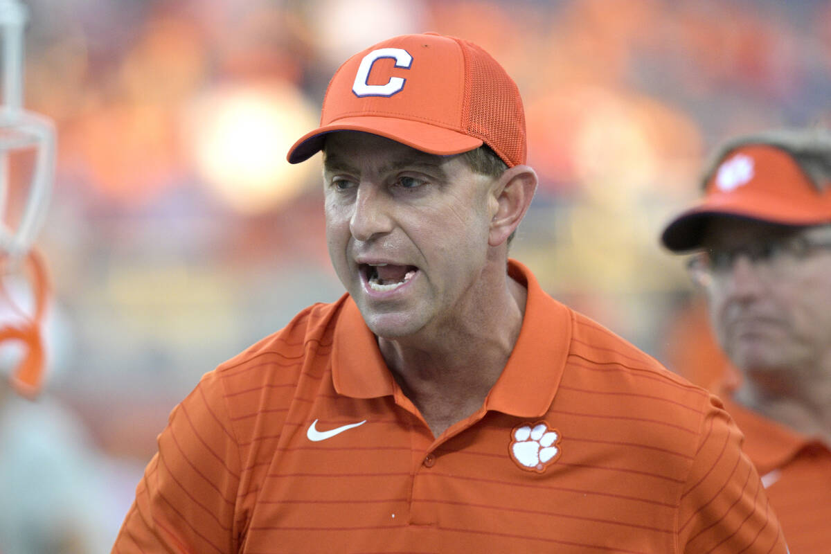 Clemson head coach Dabo Swinney calls out instructions as players warm up before the Cheez-It B ...