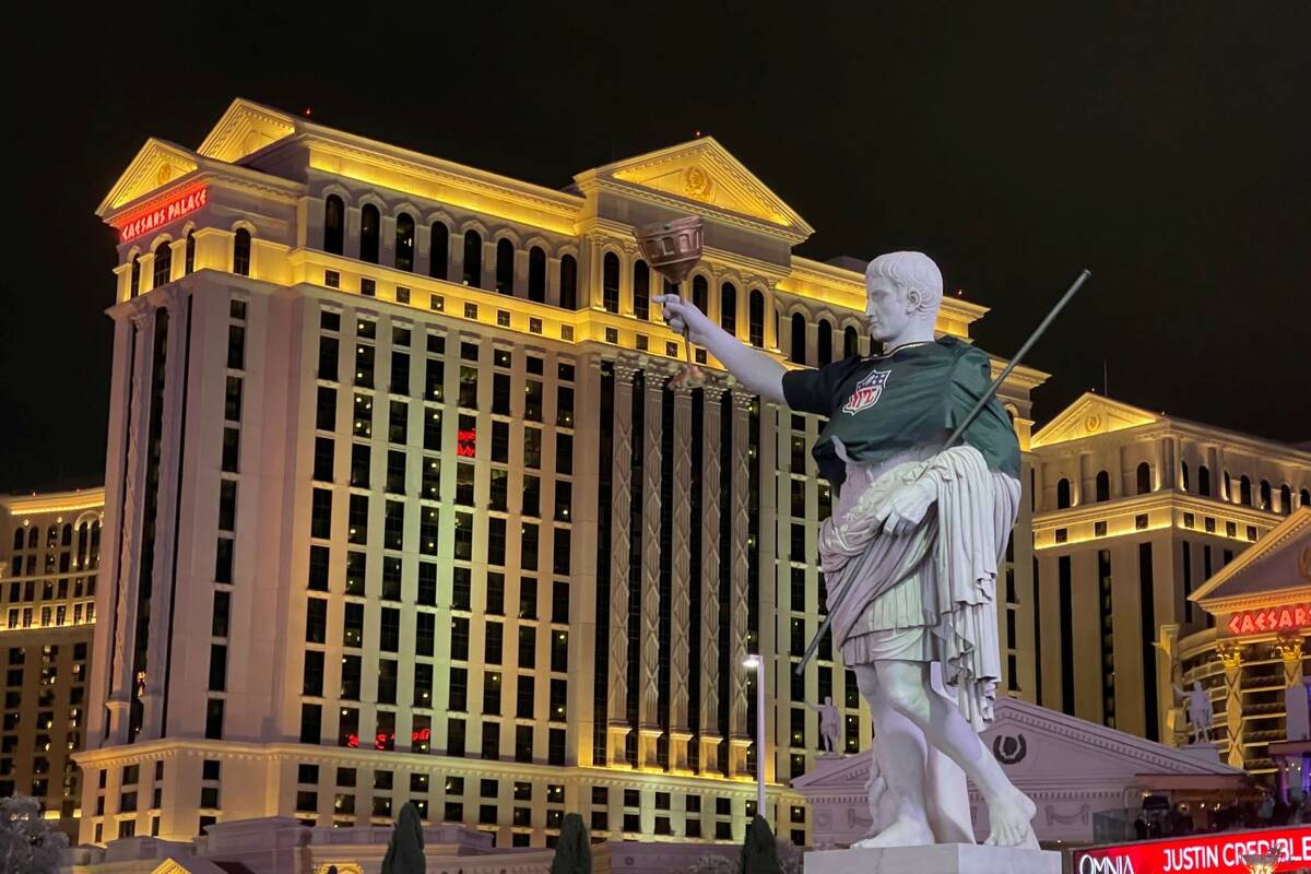 A statue in front of Caesars Palace fitted with an NFL jersey, seen here on Dec. 31, 2021. (Mic ...