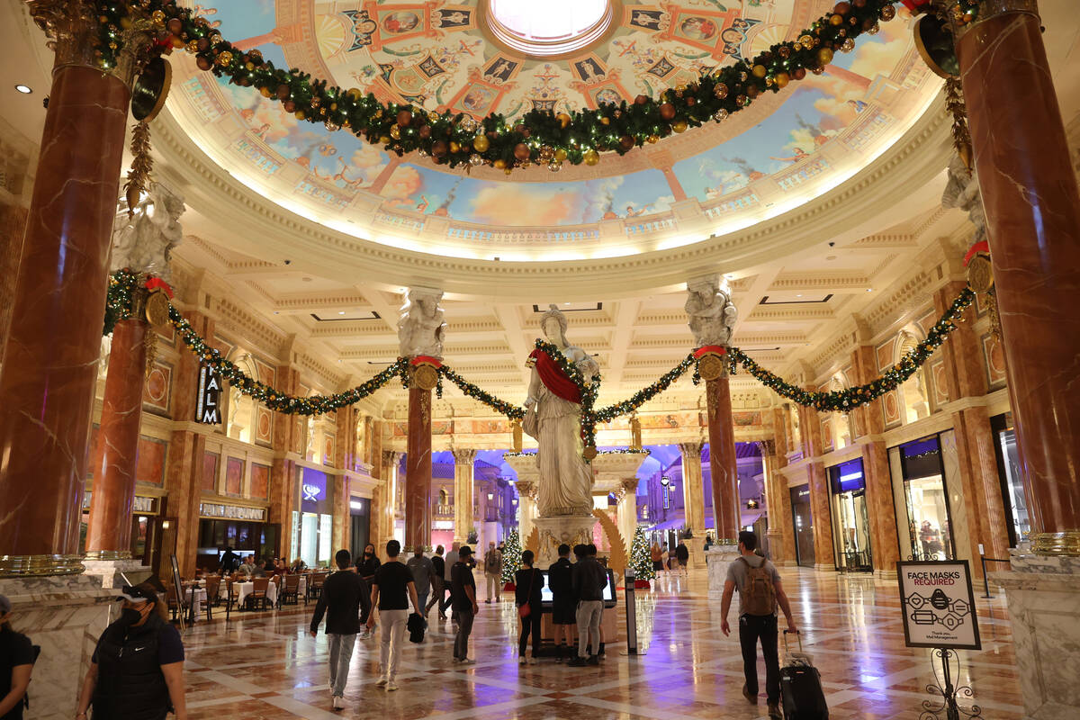 People shop at the Forum Shops at Caesars on the Strip in Las Vegas Monday, Nov. 22, 2021. (K.M ...