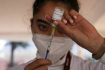 A nurse a dose of the booster against COVID-19 during a vaccination campaign for people 60 and ...