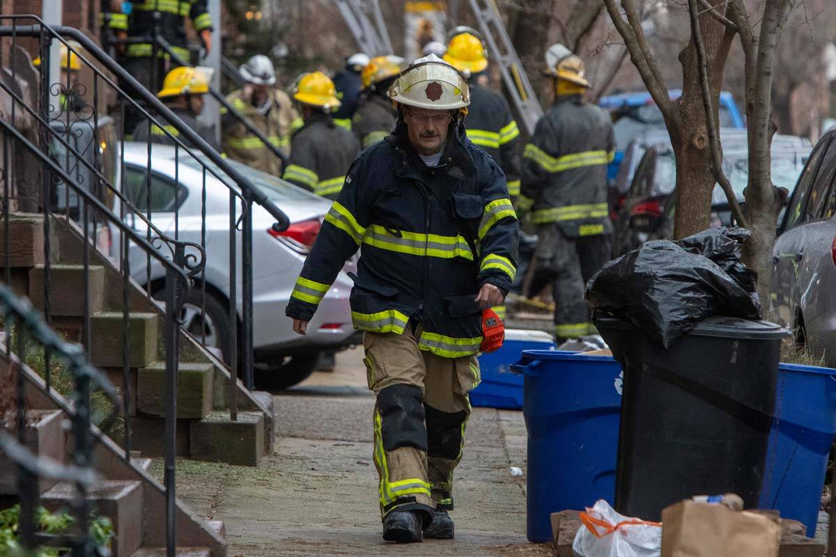 The Philadelphia fire department works at the scene of a deadly row house fire in Philadelphia ...