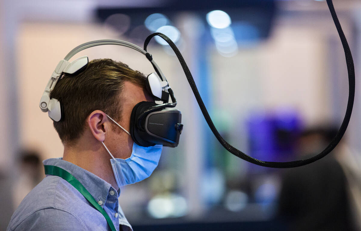 Thomas Ham, of London, plays a virtual reality game by VRLEO during CES at the Las Vegas Conven ...