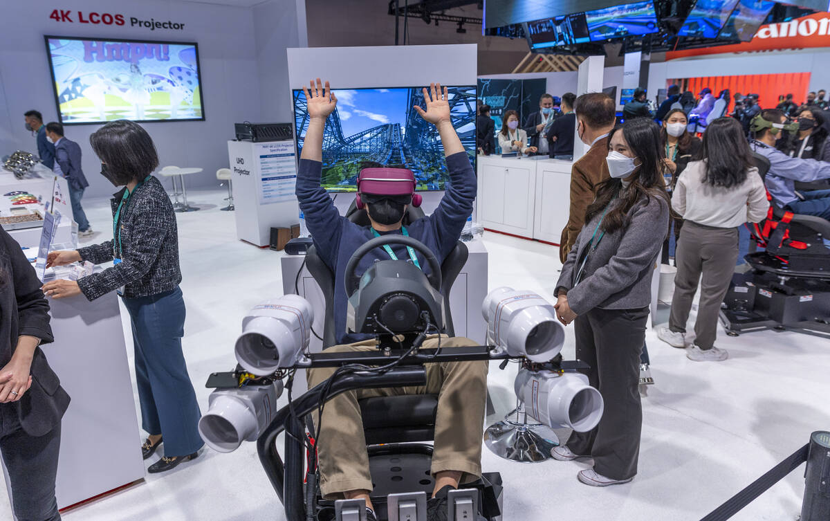 Kilho Choi rides a VR rollercoaster complete with moving chair in the May company display area ...