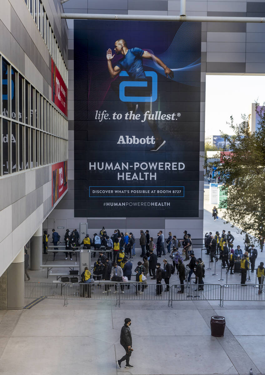 Attendees line up outside of Central Hall during the first day of CES at the Las Vegas Conventi ...