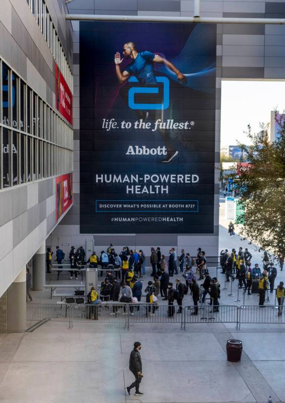 Attendees line up outside of Central Hall during the first day of CES at the Las Vegas Conventi ...