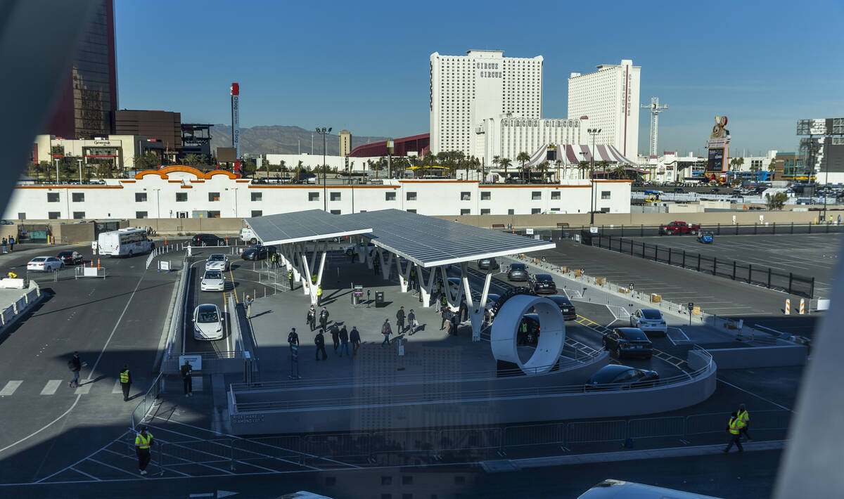 Teslas pick up passengers outside of West Hall station and head underground on the Boring Compa ...