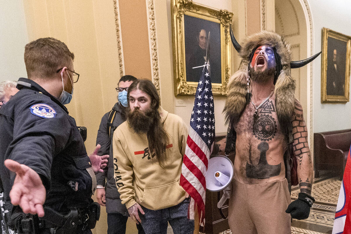 Jacob Chansley, right with fur hat, during the Capitol riot in Washington, Jan. 6, 2021. Chansl ...