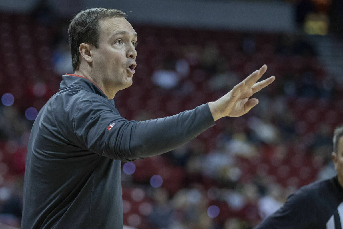 UNLV Rebels caput  manager  Kevin Kruger signals different  play   to his players versus the San Diego To ...
