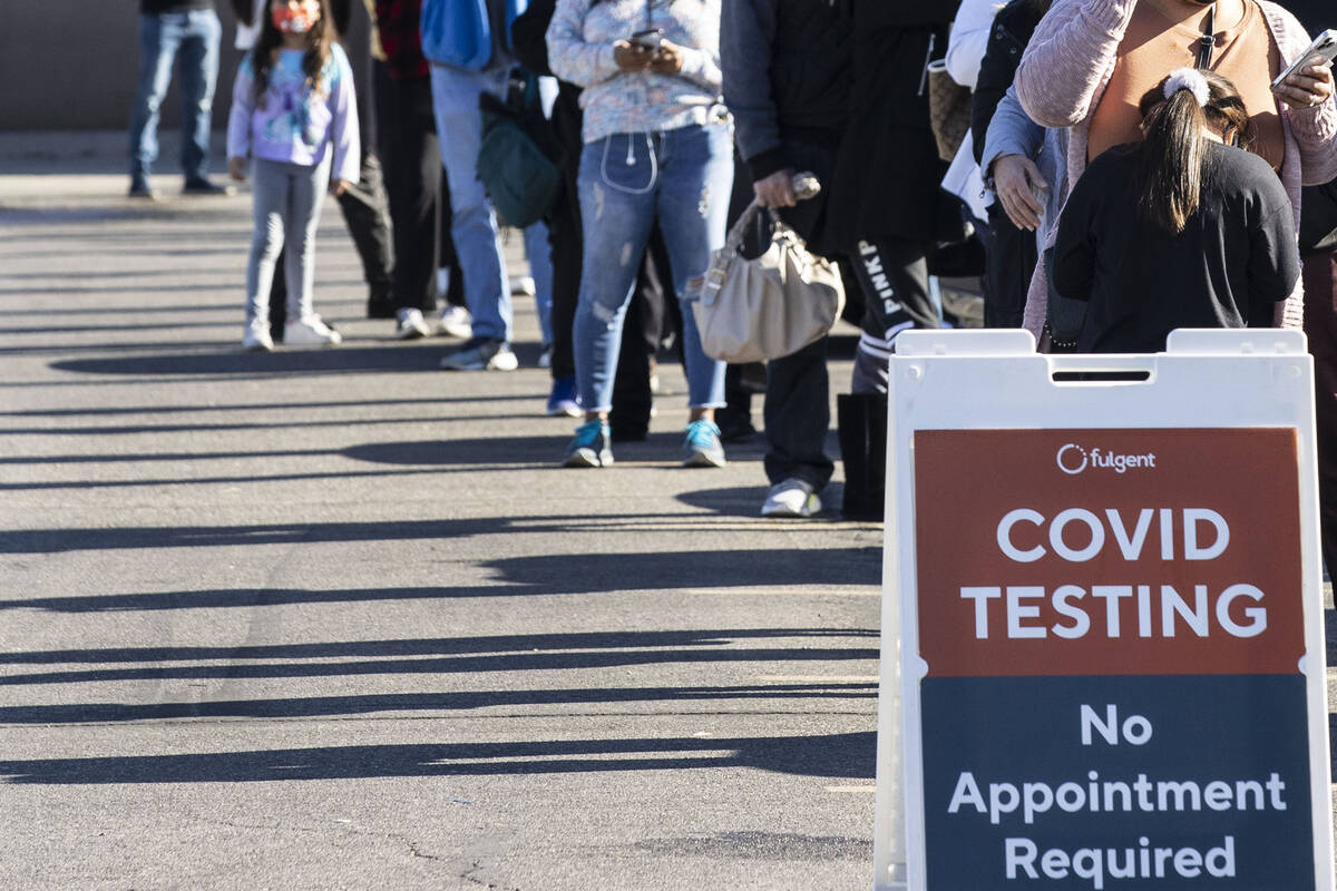 People line up to get tested for COVID-19 outside of the West Flamingo Senior Center on Tuesday ...