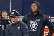 Raiders interim head coach Rich Bisaccia, left, looks on from the sideline with Raiders tight e ...