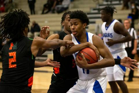 Desert Pines’ Evan Tatum (11) fights for control of the ball with Mohave’s Giali Chapman (2 ...