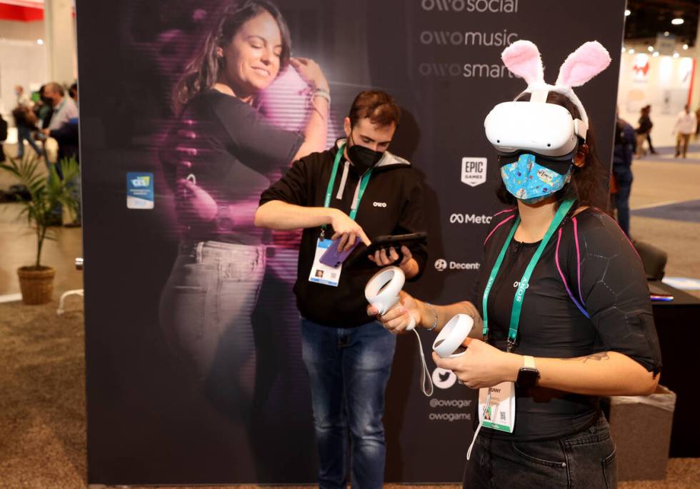 V Bunny of Las Vegas plays a virtual reality game while wearing the OWOճ wireless haptic ...