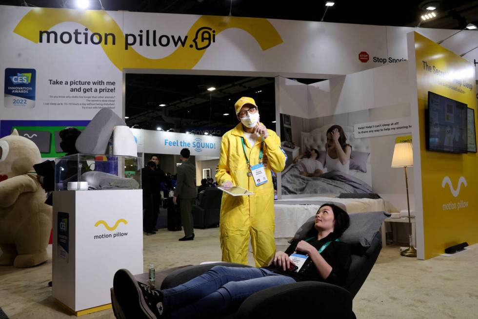 Zenora Andrade of Las Vegas shows the Motion Pillow to Tuesday Hinkle of Tucson, Ariz. during t ...
