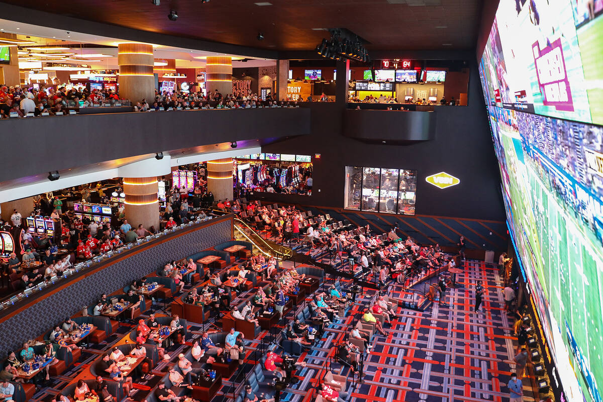 Guests watch the screens for the first week of the NFL season at the Sportsbook at Circa in Las ...