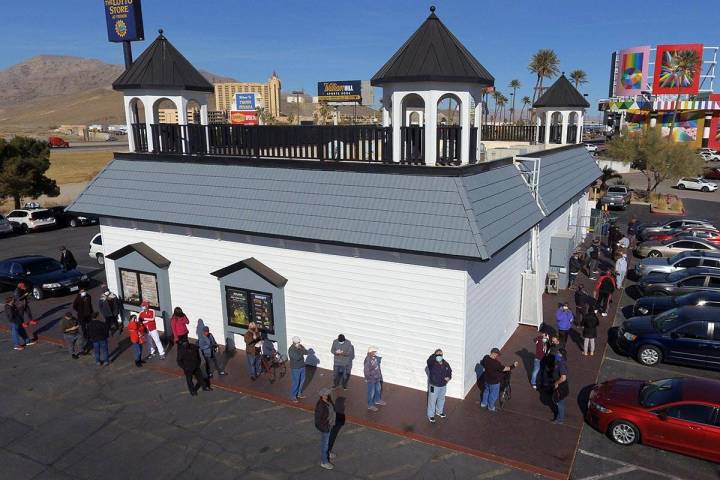 Hundreds line up outside of the Prime Valley Lotto Store as people wait to buy the Mega Million ...