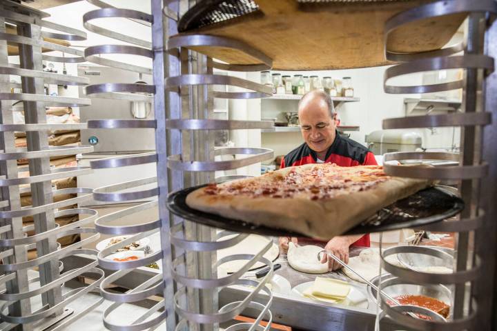 Chef/co-owner John Arena kneads pizza dough on Thursday, Feb. 2, 2017, at Metro Pizza, in Hende ...