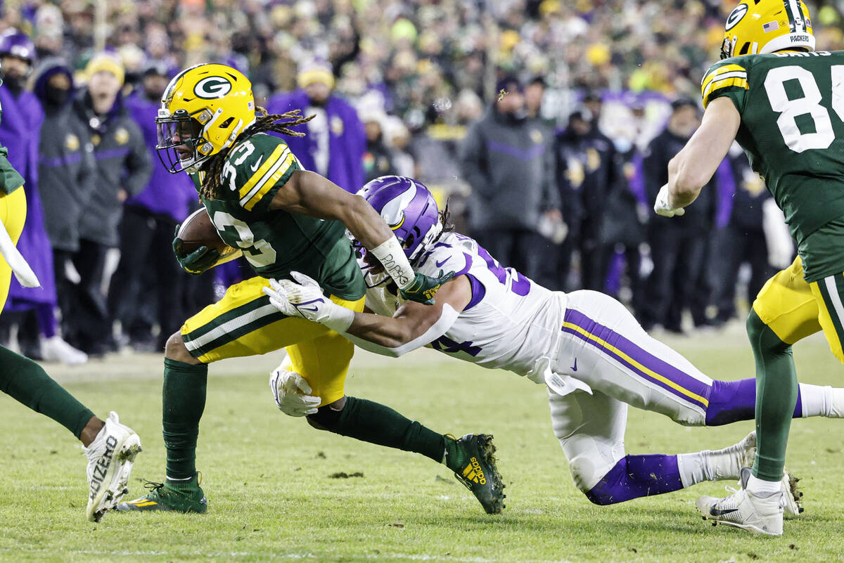 Green Bay Packers running back Aaron Jones (33) runs during an NFL football game against the Mi ...