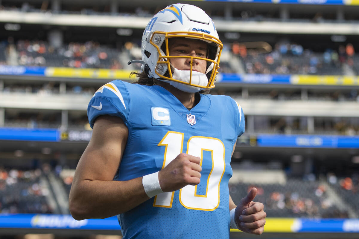 Los Angeles Chargers quarterback Justin Herbert (10) jogs back to the locker room before an NFL ...
