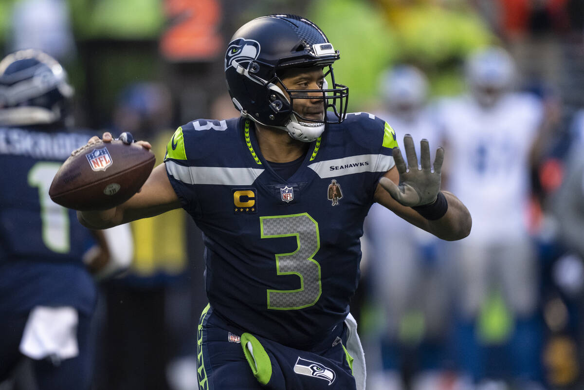 Seattle Seahawks quarterback Russell Wilson drops back to pass during an NFL football game agai ...