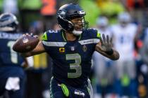 Seattle Seahawks quarterback Russell Wilson drops back to pass during an NFL football game agai ...