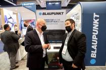 Facundo Mendez Collado of Argentina, right, mingles with Blaupunkt CEO Andrezej Cebrat during t ...
