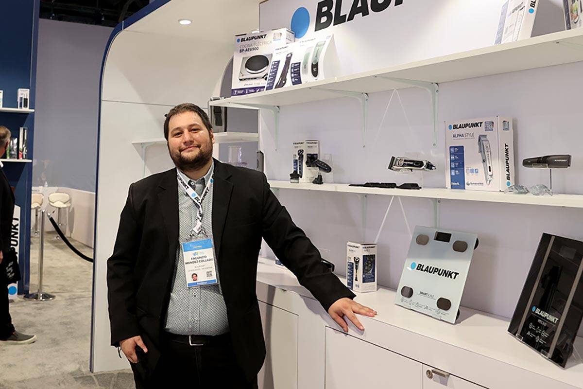 Facundo Mendez Collado of Argentina works in the Blaupunkt booth during the second day of CES a ...