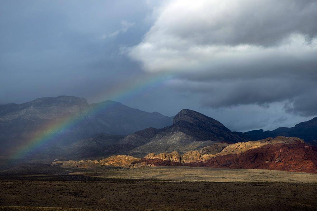 A rainbow appears above the valley floor at the Red Rock Canyon National Conservation Area as r ...