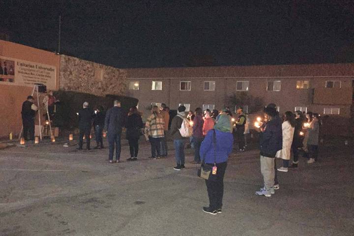 People take part in a vigil on Thursday, Jan. 6, 2022, outside the Unitarian Universalist Congr ...