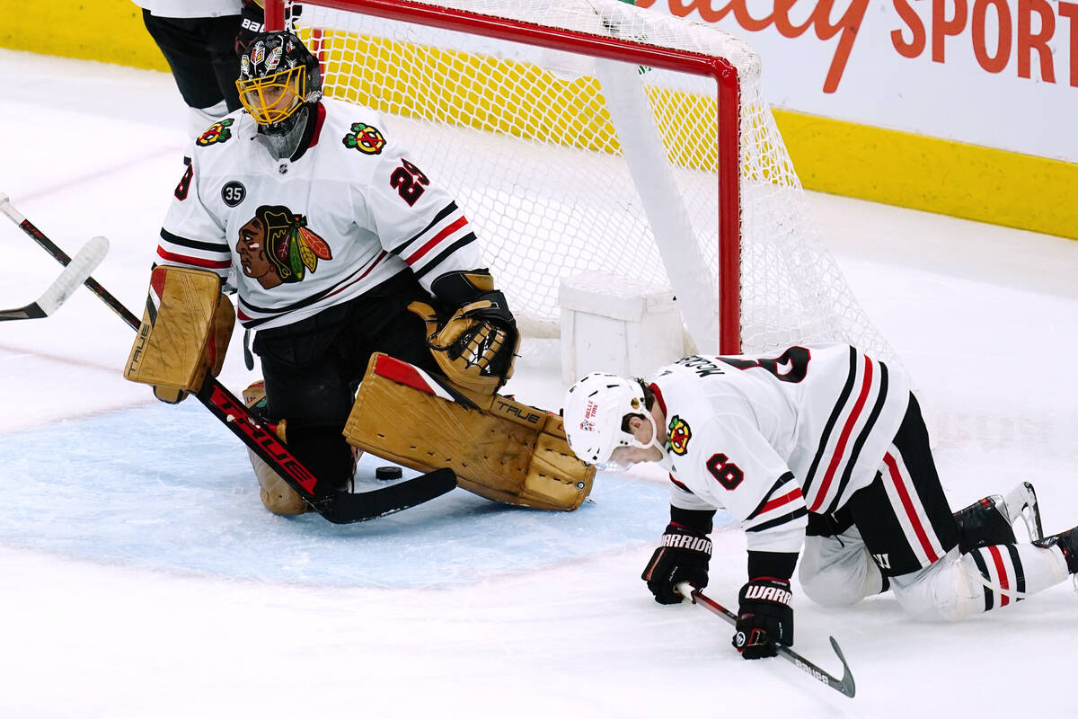 Chicago Blackhawks goaltender Marc-Andre Fleury (29) and defenseman Jake McCabe (6) pause on th ...