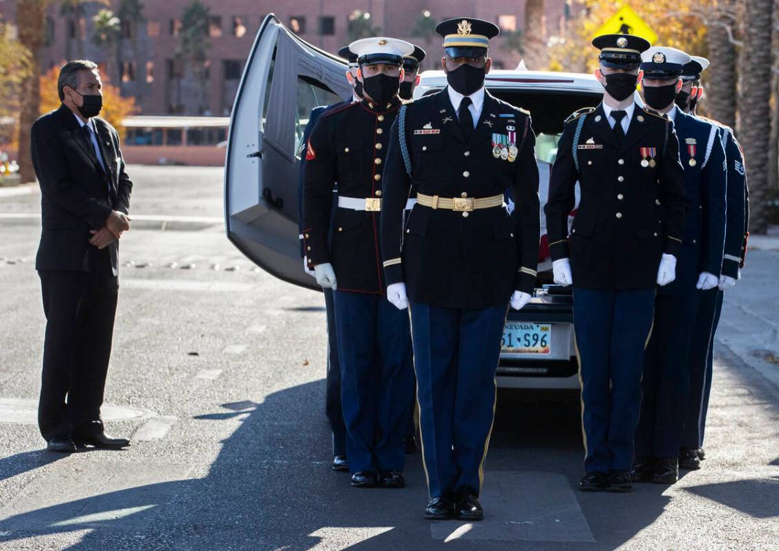 A military honor guard carries the flag-draped casket of former U.S. Sen. Harry Reid out of The ...