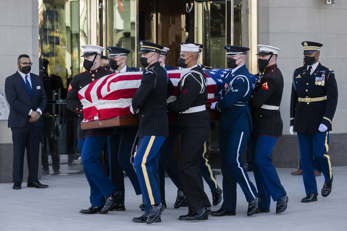 A military honor guard carries the flag-draped casket of former U.S. Sen. Harry Reid out of The ...