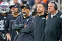 Raiders interim head coach Rich Bisaccia, center, reacts to a penalty agains the team with Raid ...