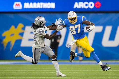 Los Angeles Chargers choky  extremity  Jared Cook (87) stiff arms Raiders wrong  linebacker Cory Little ...