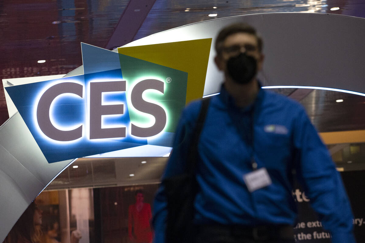 A convention attendee wears a mask to prevent the spread of COVID-19 during the third day of th ...