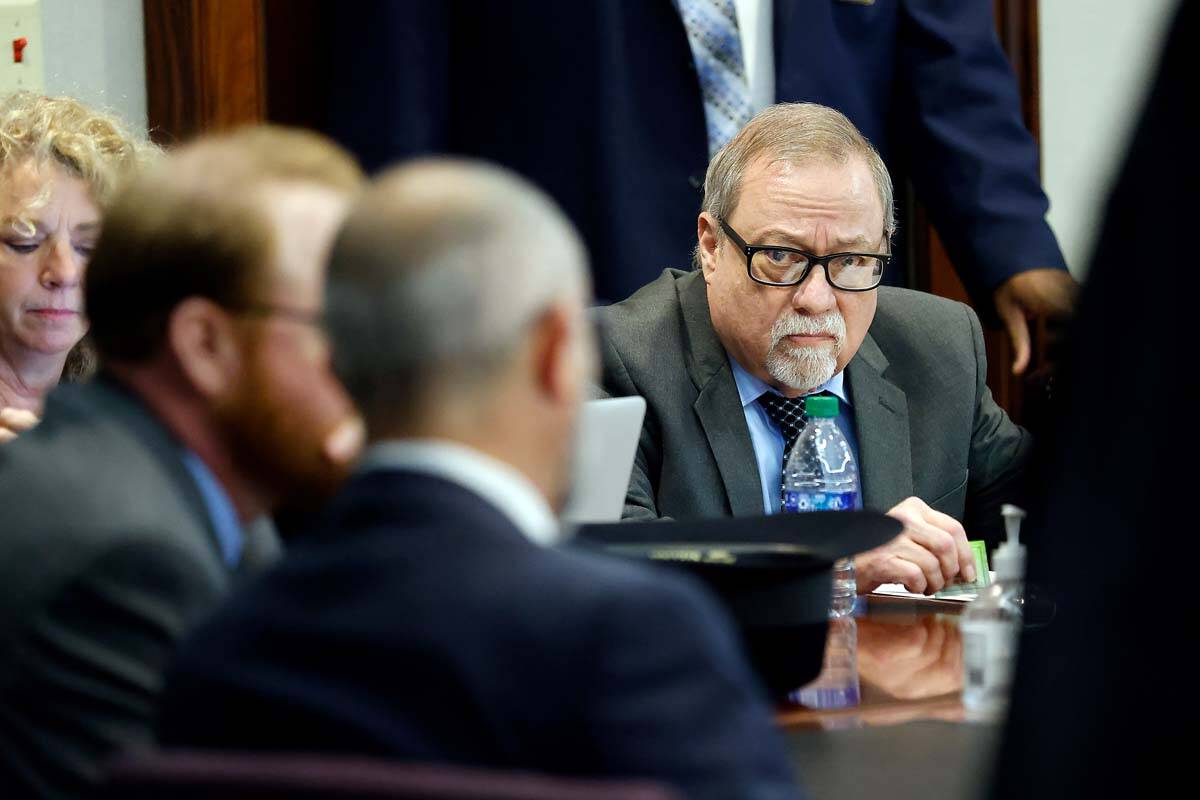 Greg McMichael, right, waits for the sentencing of he and his son Travis McMichael, and a neigh ...
