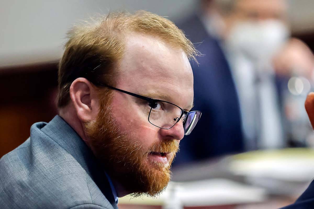 Travis McMichael, left, speaks with his attorney Jason B. Sheffield during the sentencing of he ...