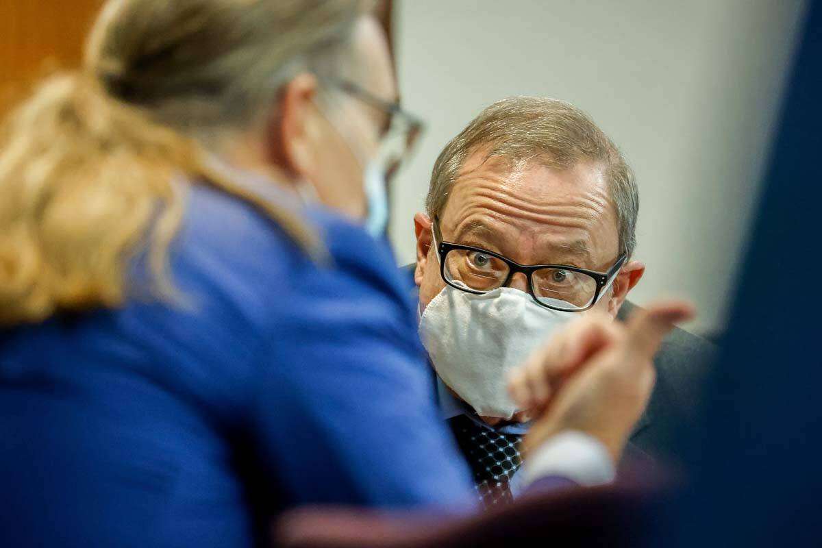 Greg McMichael, center, listens to his attorney Franklin Hogue during sentencing of he and his ...
