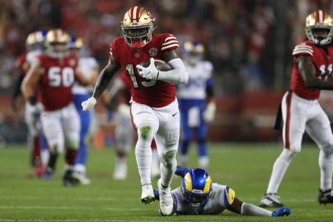 San Francisco 49ers wide   receiver Deebo Samuel (19) runs past   Los Angeles Rams information   Jordan Fu ...