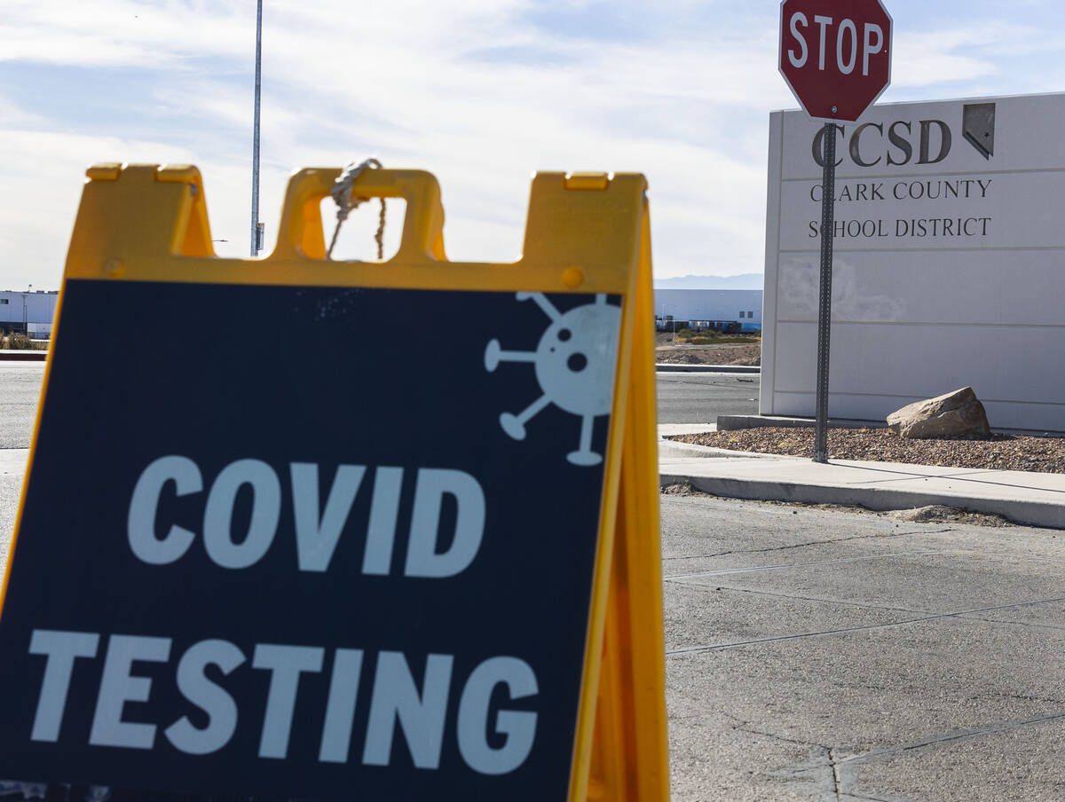 A COVID testing sign is displayed at the main gate of the Clark County School District building ...